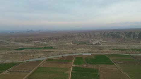 An-aerial-shot,-captured-by-drone-of-a-rural,-agricultural-landscape-in-a-remote-village-setting-located-within-Afghanistan