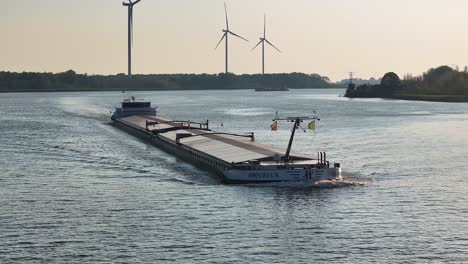 AMOUREUS-Cargo-Ship-Cruising-On-River-In-Barendrecht,-Netherlands---Aerial-Drone-Shot