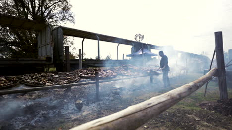 Open-air-view-of-a-massive-Argentine-asado-with-numerous-grills-and-meats---slow-motion