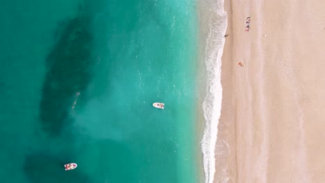 Inflatable-Boats-Off-The-Shore-Of-Cala-Sisine-Beach-On-Gulf-of-Orosei-In-Sardinia,-Italy