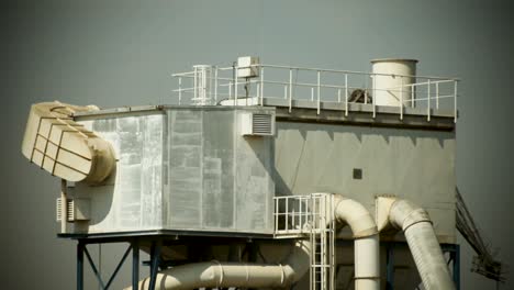 Industrial-air-conditioning-units-on-a-building-roof-against-a-stormy-sky,-detailed-mechanical-and-structural-elements