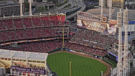 Cincinnati-Ohio-Aerial-v66-zoomed-fly-around-packed-Great-American-Stadium,-Reds-team-plays-on-home-ground,-surrounded-by-cheering-fans-in-the-bleachers---Shot-with-Mavic-3-Pro-Cine---September-2023