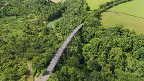 Aerial-view-of-Meldon-Viaduct-and-Okement-Valley,-showcasing-the-picturesque-landscape-and-historic-bridge