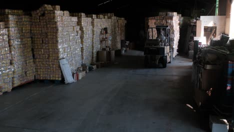 Person-driving-forklift-into-warehouse-to-drop-off-pallet