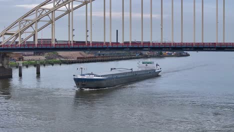 Primair-Cargo-Ship-On-Cruising-On-River-Noord-Under-Bridge-Over-The-Noord-In-Alblasserdam,-Netherlands