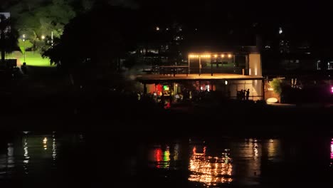 Aerial-view-of-people-having-a-party-at-night-in-a-club-near-Parana-river-in-city-of-Posadas