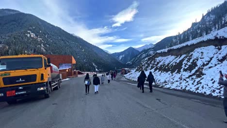 Blue-lake-is-in-the-middle-of-the-mountains-of-Kolsai-Lakes-Natural-Park-with-tourists