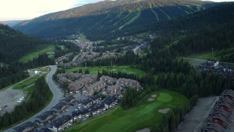 Tilting-up-from-small-town-to-mountains-above-in-Canadian-countryside