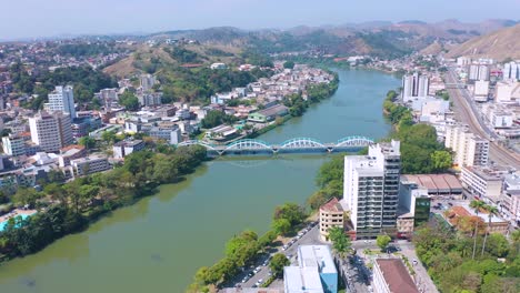 Sunny-Aerial-view-of-the-Ataulpho-Pinto-dos-Reis-bridge-over-the-Paraíba-do-Sul-river-in-Barra-Mansa,-Rio-de-Janeiro,-Brazil