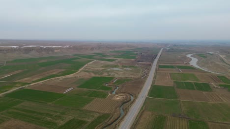 An-aerial-shot,-captured-by-drone-of-a-rural,-agricultural-landscape-in-a-remote-village-setting-located-within-Afghanistan