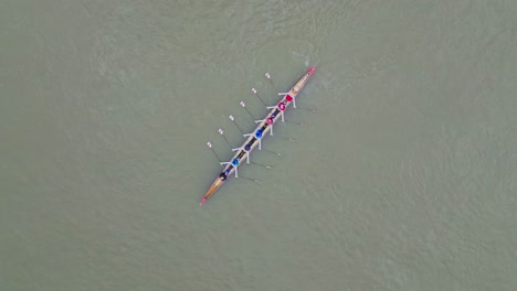 Aerial-perpendicular-drone-view-of-people-rowing-on-the-Neckar-river-in-Heidelberg,-Baden-Württemberg,-Germany