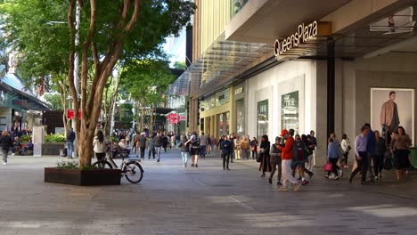 Shoppers-shopping-at-premium-Queens-Plaza,-dinning-at-Queen-street-mall,-outdoor-pedestrian-shopping-precinct-in-downtown-Brisbane-city,-slow-motion-shot,-concept-of-inflation-and-cost-of-living