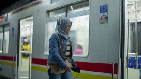 Kampung-bandan-Electric-Train-Station,-female-boarding-rail-carriage