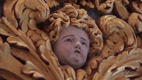 A-tilt-down-shot-of-a-detailed-seraphim's-face-at-the-Co-Cathedral-in-Valletta,-Malta