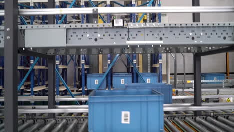 Automatic-smart-system-for-carry-arrange-basket-plastic-box-to-conveyor-belt-line-storage-on-shelf-In-A-Large-Scale-Smart-Distribution-Warehouse,-Production-Line