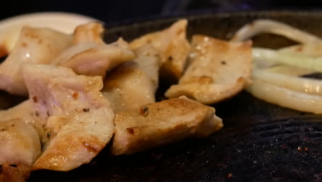 Close-up-of-barbecuing-meat-over-an-open-flame-at-a-Chinese-restaurant