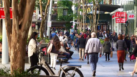 Slow-motion-shot-of-crowd-of-people-shopping-and-dinning-at-Queen-street-mall,-outdoor-pedestrian-shopping-precinct-at-downtown-Brisbane-city,-concept-of-inflation-and-cost-of-living