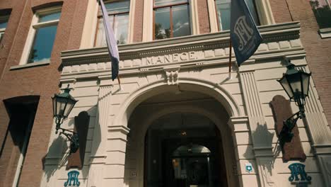 Exterior-of-Hollandsche-Manege-facade-building-in-Amsterdam,-Netherlands-with-sunlight-highlighting-its-historic-architecture