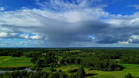 Aerial-moving-shot-of-dense-clouds-over-countryside-green-lands