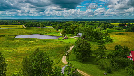 Clouds-cast-shadows-over-farmland-fields-and-reflect-off-water-in-ponds-in-this-countryside---aerial-hyper-lapse