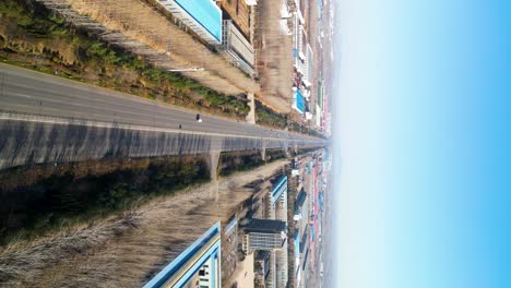 Vertical-aerial-shot-revealing-an-industrial-area-and-highway-with-Chinese-factories-in-the-outskirts-of-Linyi,-Shandong-Province,-China