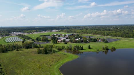 Stunning-aerial-footage-of-a-solar-farm-and-campus-surrounded-by-lush-greenery