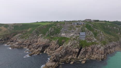 Aerial-revealing-shot-of-the-Minack-theatre-and-the-surrounding-ocean-bay