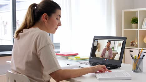 education,-online-school-and-distant-learning-concept--student-woman-with-notebook-and-book-watching-tutorial-video-on-laptop-computer-at-home