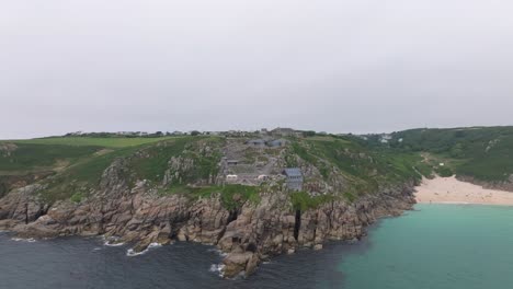 Aerial-shot-of-the-beautiful-Minack-Theatre-with-Porthcurno-Beach-on-a-summers-day