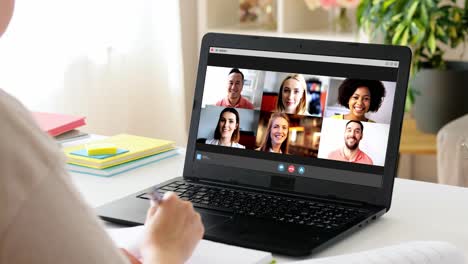 education,-online-school-and-distant-learning-concept--student-woman-with-notebook-and-book-having-video-call-on-laptop-computer-at-home