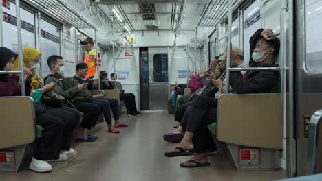 Pasajeros-Sentados-Y-Usando-Sus-Teléfonos-Celulares-Dentro-Del-Vagón-De-Tren-En-La-Estación-Sudimara-En-Tangerang-Selatan