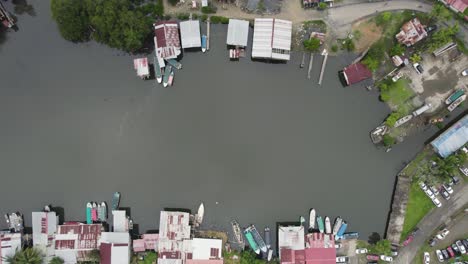 Aerial-of-Almirante,-Panama-showcasing-rooftops,-boatsalong-waterway