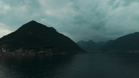 Beautiful-view-of-Lake-Iseo-surrounded-by-mountains-under-a-cloudy-sky