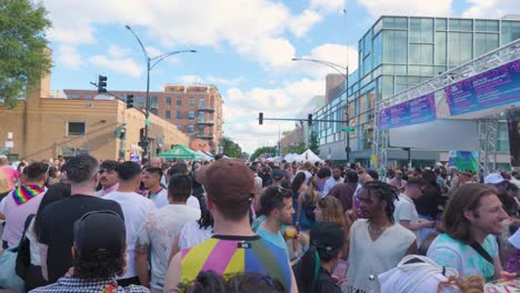 Vibrant-Pride-Festival-Crowd-Celebrating-Under-the-Summer-Sky-The-crowd,-adorned-in-rainbow-patterns,-gathers-under-the-open-sky-to-celebrate-at-gay-pride