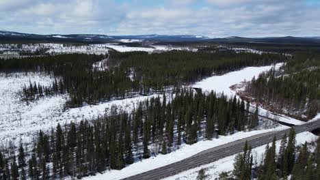 Panoramic-View-Of-Conifer-Forest-Near-Main-Highway-During-Winter-In-Sweden