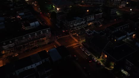 Aerial-top-down-of-traffic-on-junction-in-quiet-small-town-of-USA-at-night