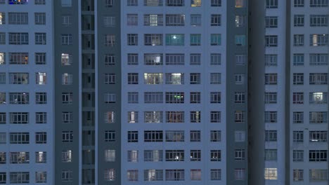 Large-Hi-Rise-Residential-Building-Facades-Aerial-View-at-night-with-drone-moving-across-from-left-to-right