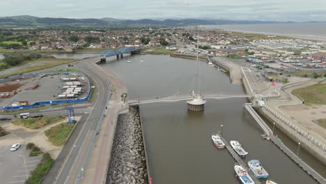 An-aerial-view-of-the-of-the-Foryd-Road-Bridge-and-Pont-y-Ddraig-Harbour-Bridge-in-Denbighshire,-Wales,-on-an-overcast-day