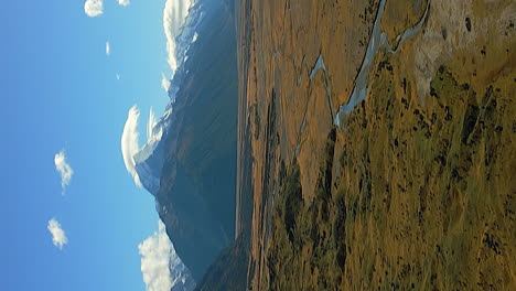 The-Tasman-River-in-the-basin-beneath-Mont-Cook,-Aoraki,-New-Zealand---vertical-aerial