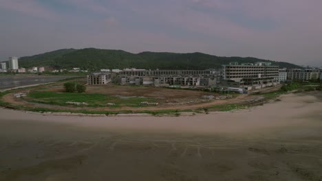 Aerial-view-of-a-construction-site-under-development-in-Ha-Long,-Vietnam,-highlighting-ongoing-progress-and-the-evolving-infrastructure