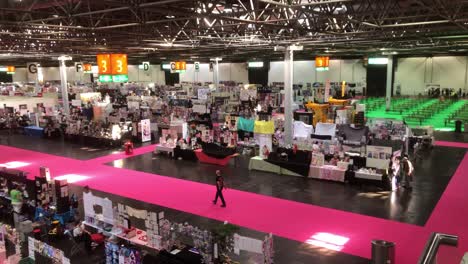 panning-shot-showing-the-Artists-and-creatives-set-up-their-stalls-for-the-Dokomi-event-in-Dusseldorf,-Germany,-29