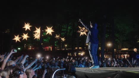 Hans-Philip-from-Ukendt-Kunstner-and-Lord-Siva,-performing-at-Skanderborg-festival-in-Denmark,-in-front-of-a-large-crowd