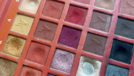 Close-up-of-brush-in-the-eyeshadow-palette,-used-to-select-different-colors