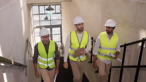 Builder-in-Helmet-with-Clipboard-Walking-Upstairs