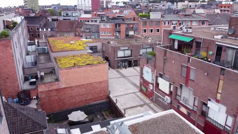 Commercial-street-aerial-zoom-out-with-cityscape-view-of-Genk,-Belgium