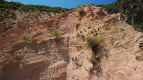 Sedimentary-red-rock-cliff-eroded-by-water