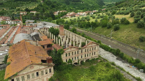 Abandoned-ceramic-factory-in-Italy-with-overgrown-greenery-and-historic-architecture