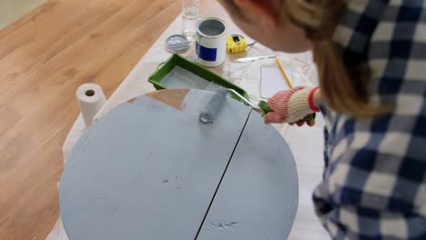 Woman-Painting-Old-Wooden-Table-or-Chair-in-Grey