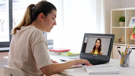 Educación,-Escuela-En-Línea-Y-Concepto-De-Aprendizaje-A-Distancia-Mujer-Estudiante-Con-Cuaderno-Y-Libro-Viendo-Videos-Tutoriales-En-Una-Computadora-Portátil-En-Casa