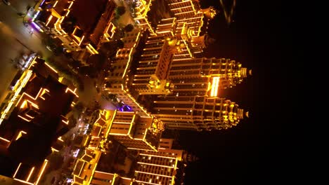 Vertical-aerial-shot-of-Boten-in-Laos,-architecture-by-night